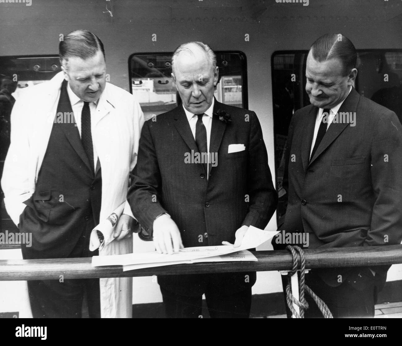 Henry Ford II looking over plans with two colleagues Stock Photo