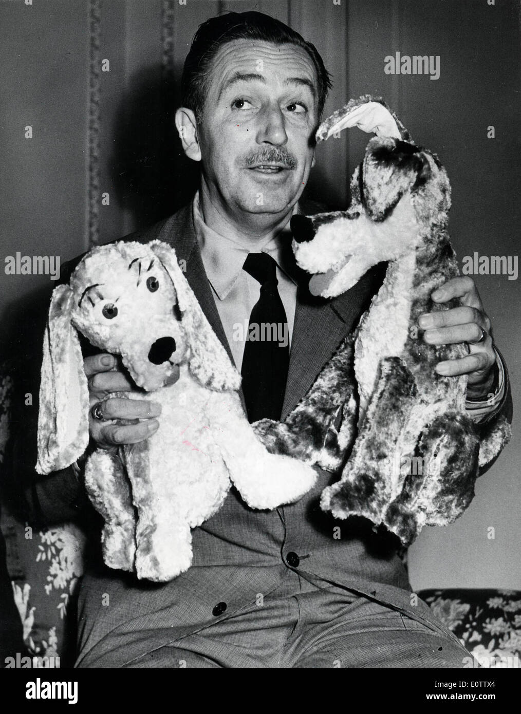 Walt Disney playing with stuffed animals Stock Photo