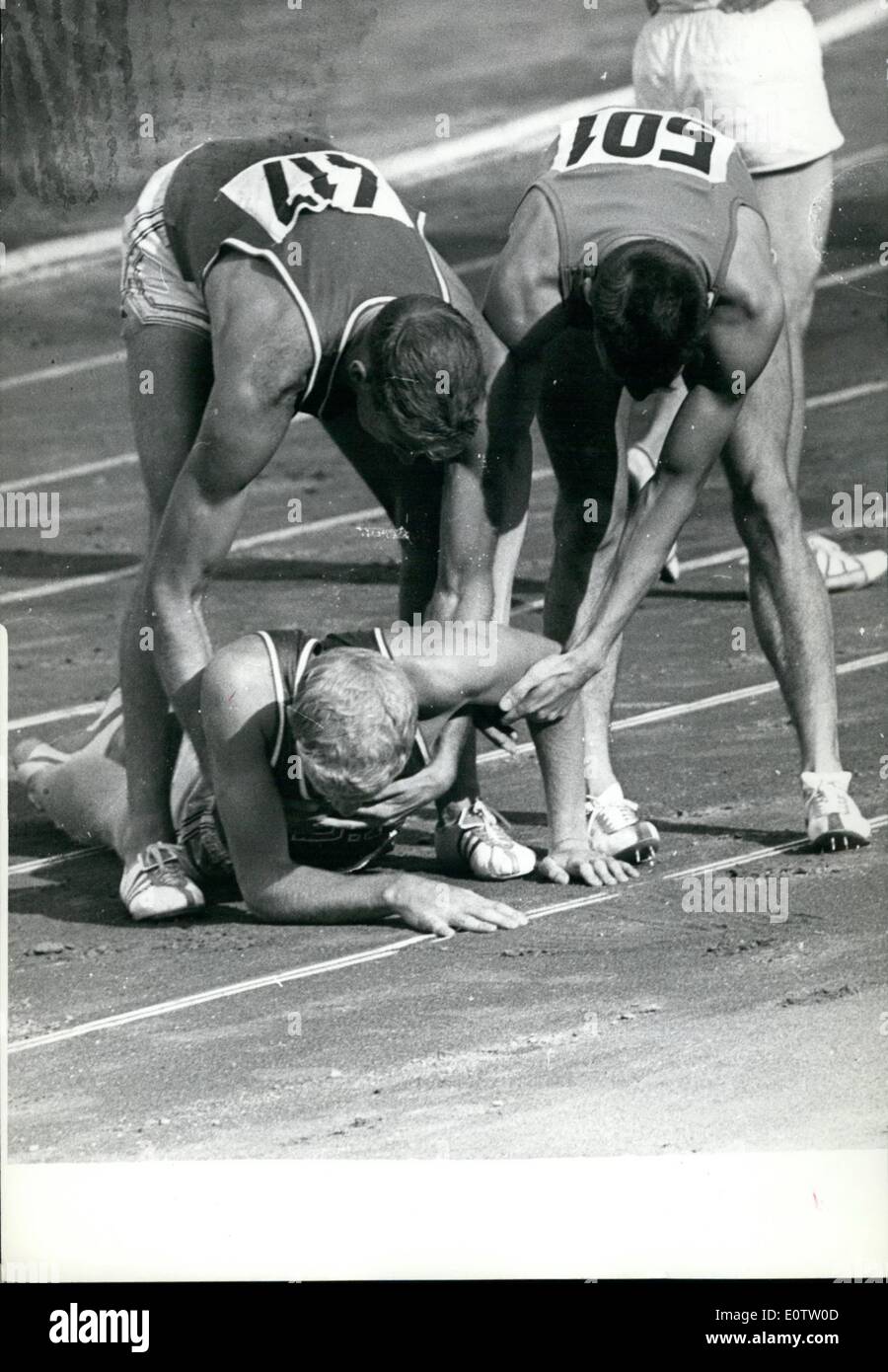 Sep. 09, 1960 - Winner Assists Fellow Countryman. Cliff Cushman (USA) fell as he passed the finishing line taking second place in the 400 metres Hudles final this afternoon. Winner was G. Davis with Richard Howard in third place. All Americans. Photo shows Cushman is assisted by Glenn Davis (left) and John Rintamaki (Finland) (501) after falling. Stock Photo