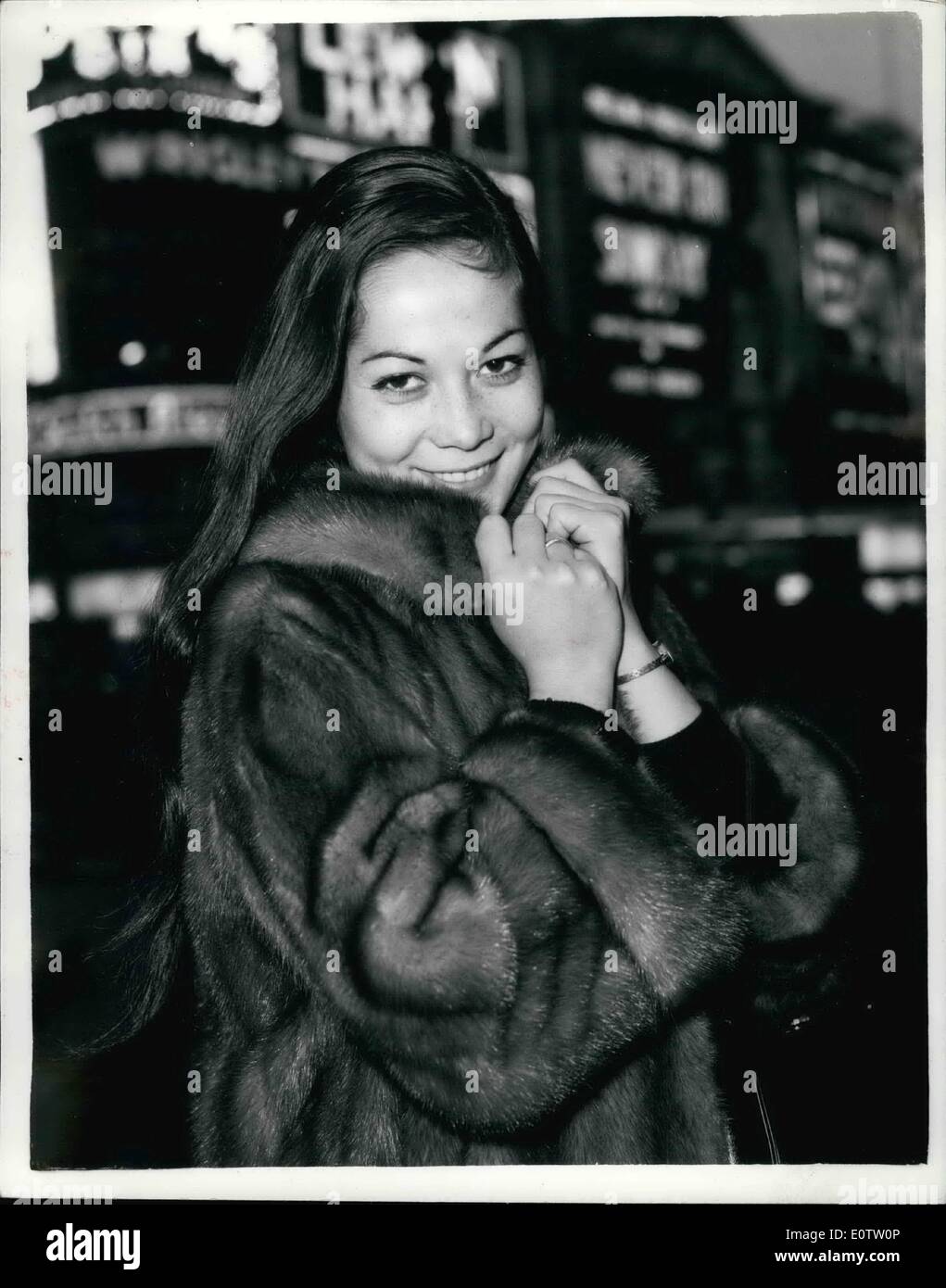 Sep. 12, 1960 - 9-12-60 Nancy Kwan goes sight-seeing in Piccadilly Circus. Nancy Kwan the star of the new film The World of Suzie Wong here for the premiere next Wednesday, went for a sightseeing tour of London this morning. Keystone Photo Shows: Nancy Kwan snuggles up into her coat in the cold breeze at Piccadilly Circus this morning. Stock Photo