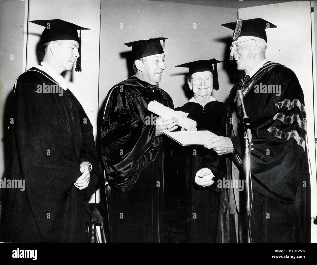 Walt Disney receiving his diploma at graduation Stock Photo
