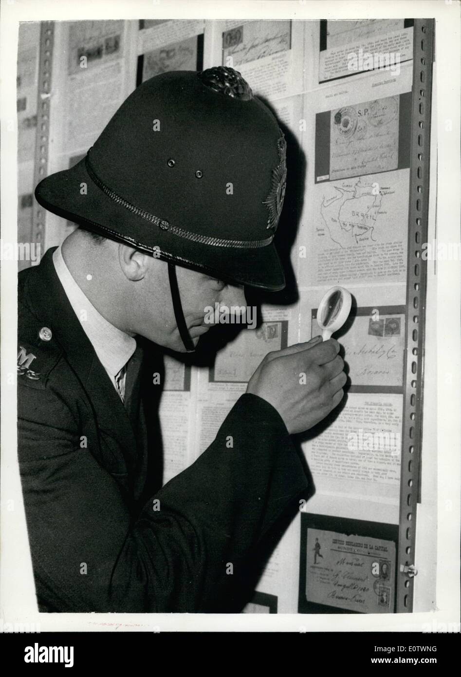 Aug. 08, 1960 - Press view of the London International Stamp Exhibition. Policeman looks at a stamp. A press view was held this Stock Photo