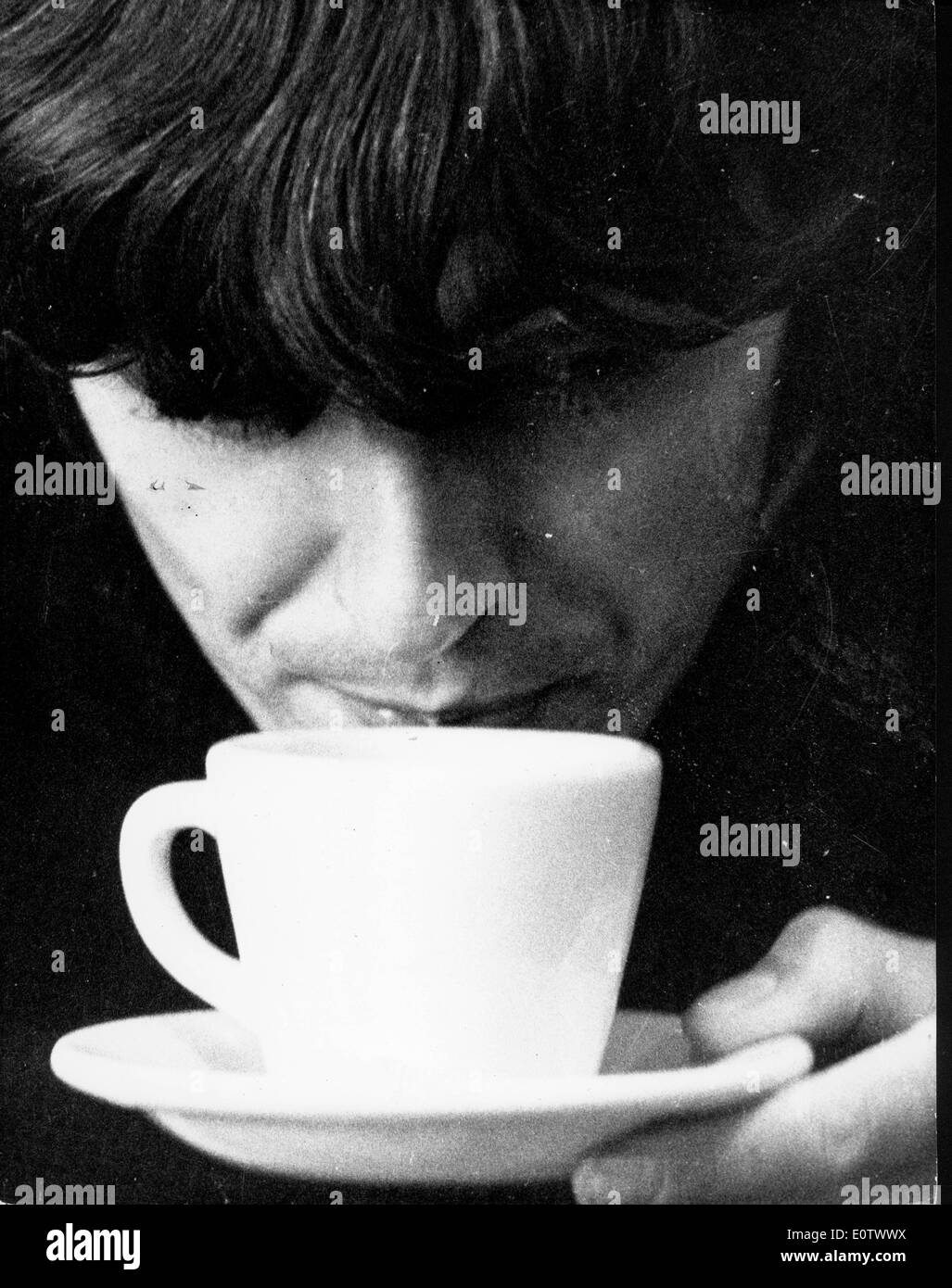 Beatle guitarist George Harrison cooling his cup of coffee Stock Photo