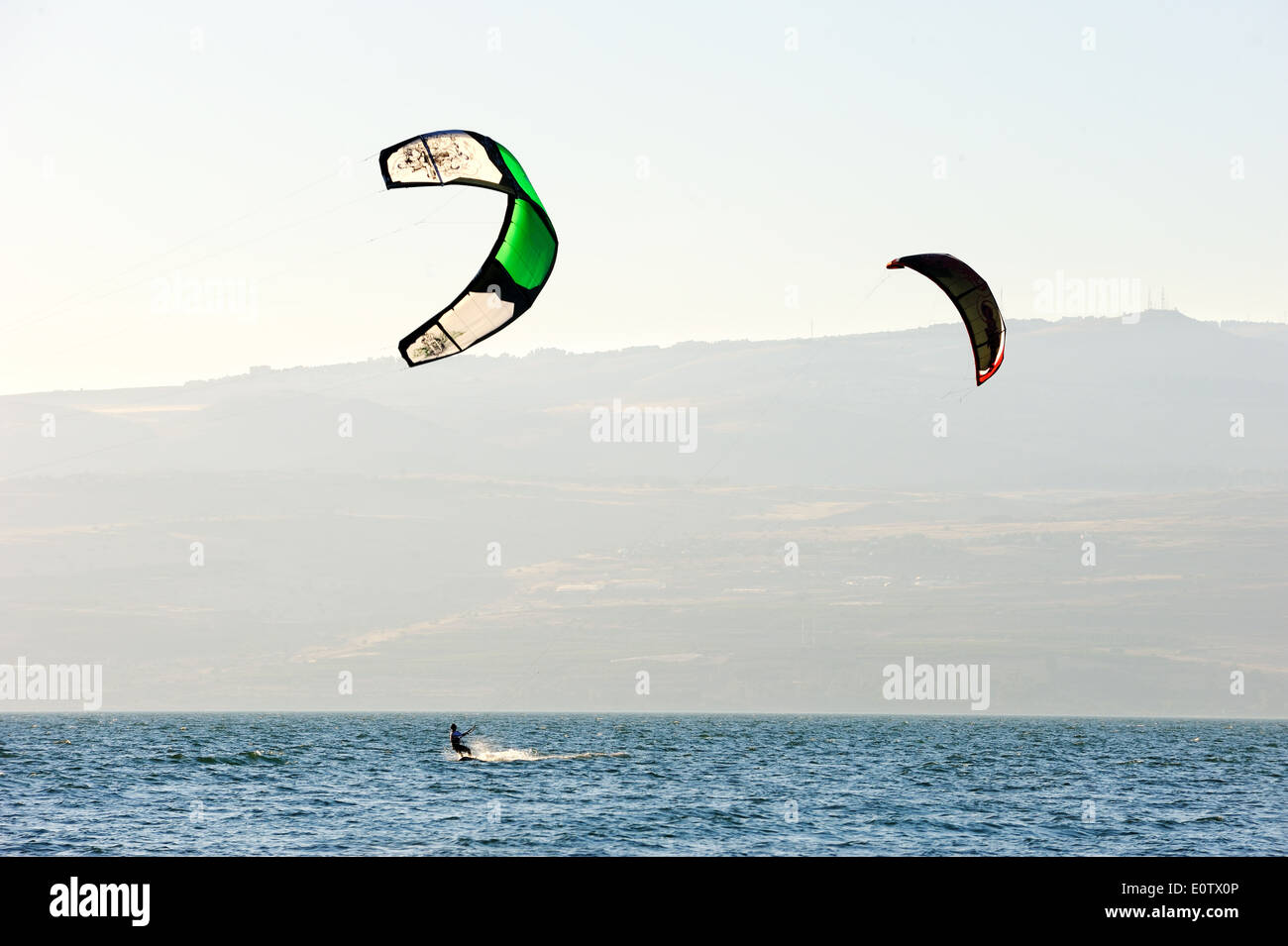 Sky-surfing in the rays of the setting sun on lake Kinneret Stock Photo
