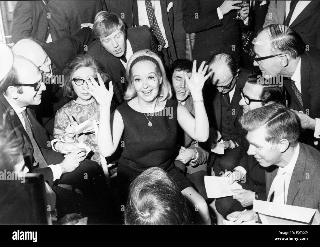 Actress Betty Grable surrounded by people and fans at an event Stock Photo