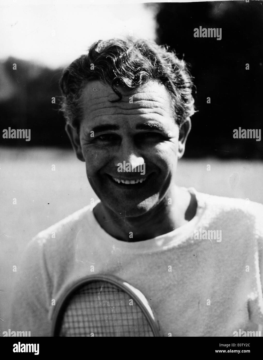 Actor Donald Gray taking a break from a tennis game Stock Photo