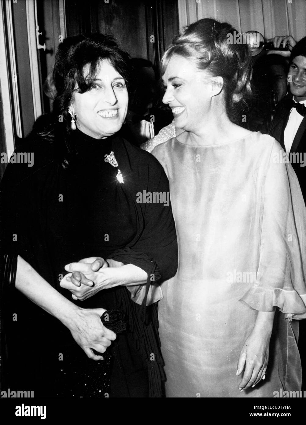 Actresses Anna Magnani and Jeanne Moreau at party Stock Photo
