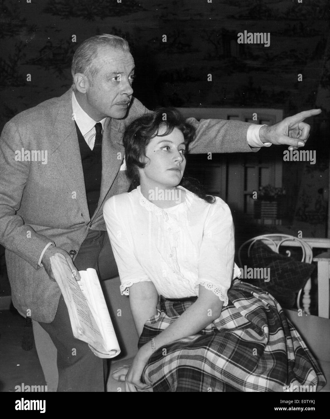 Actor Fernand Gravey directing an actress Stock Photo