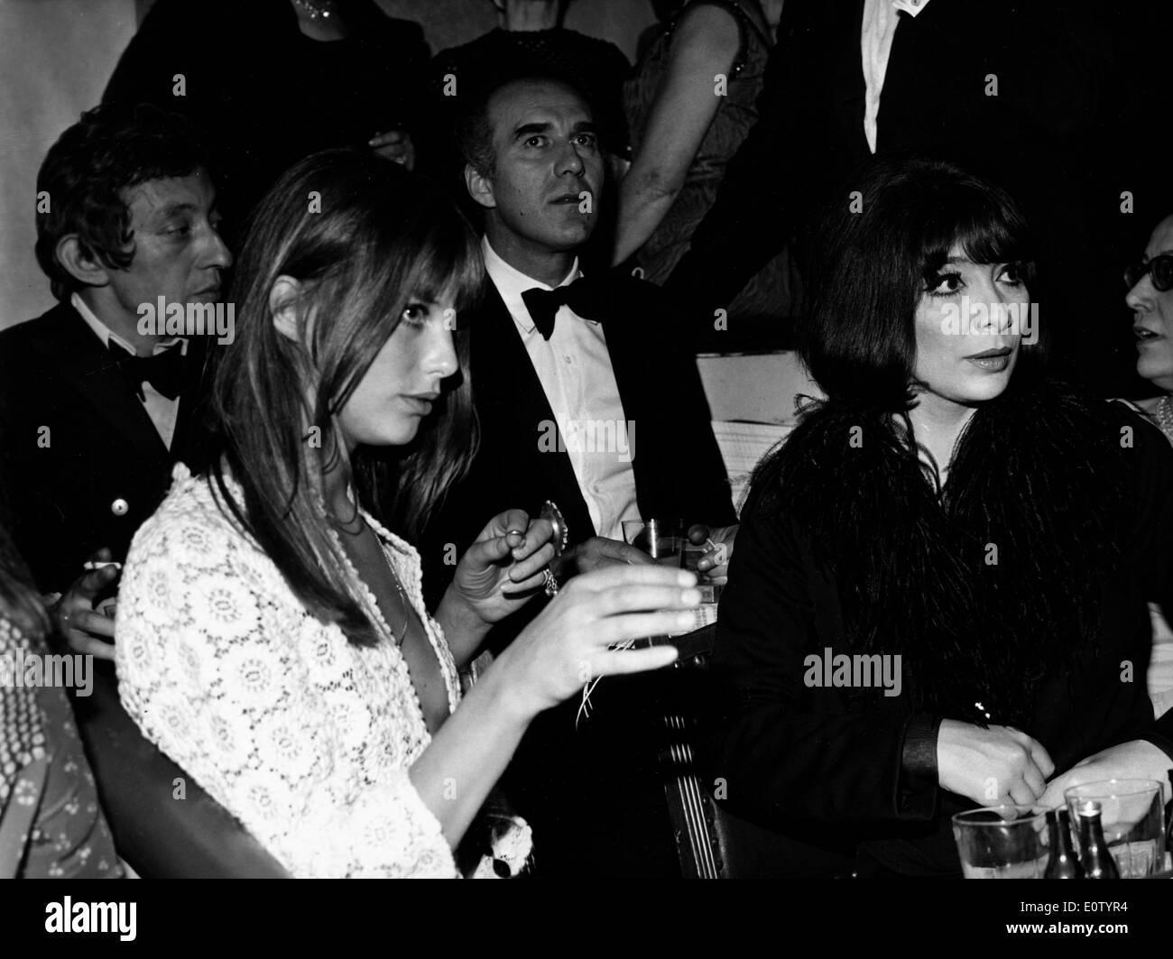 Actress Juliette Greco sitting at a reception with friends Stock Photo