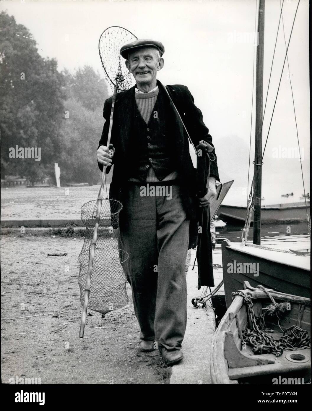 Oct. 10, 1960 - ANGLER ALBERT'S GREATEST CATCH &pound;57,000 It was the fifth catch of the day that surprised 71 year old angler, ALBERT ROBERTS. He was fishing from a bank of the River Thames with four roach tucked away in his catch box when the man from the football pools walked up and said; ''You have won &pound;57,323''. Albert thoughtfully reeled in his line, collected his tackle, then turned to the stranger and said. ''Well that's handy, mate''. Mr, Roberts, father of seven, and a retired coalman, had won two littlewoods Treble Chance first dividends Stock Photo