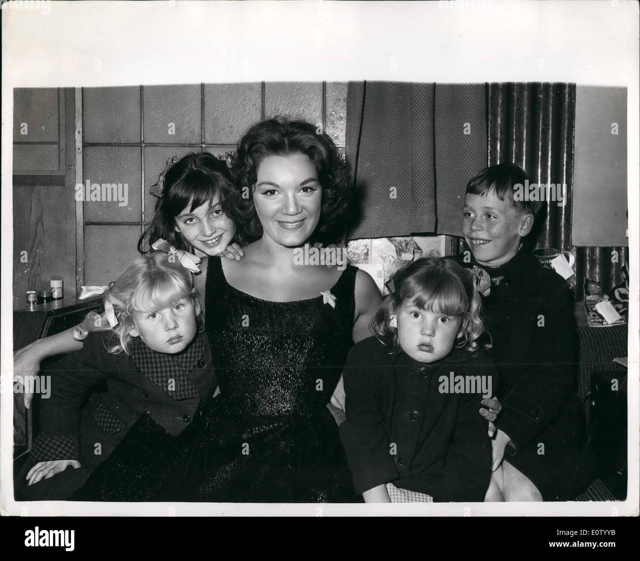 Oct. 10, 1960 - CONNIE FRANCIS AND THE COCKNEY KIDS... SHE WILL PAY FOR A HOLIDAY FOR THEM.. Pop singer Connie Francis was to be seen at the London Palladium yesterday - with four Cockney children Lorraine Woods (10); Alan (9); Valerie (5) and Yvonne (3) between rehearsals for the Sunday Night TV show.. This followed the announcement by her publicity agent that she was to have four cockney children as 'mascots' and that she would 'kinda adopt one of them... pay its way' ..... Stock Photo