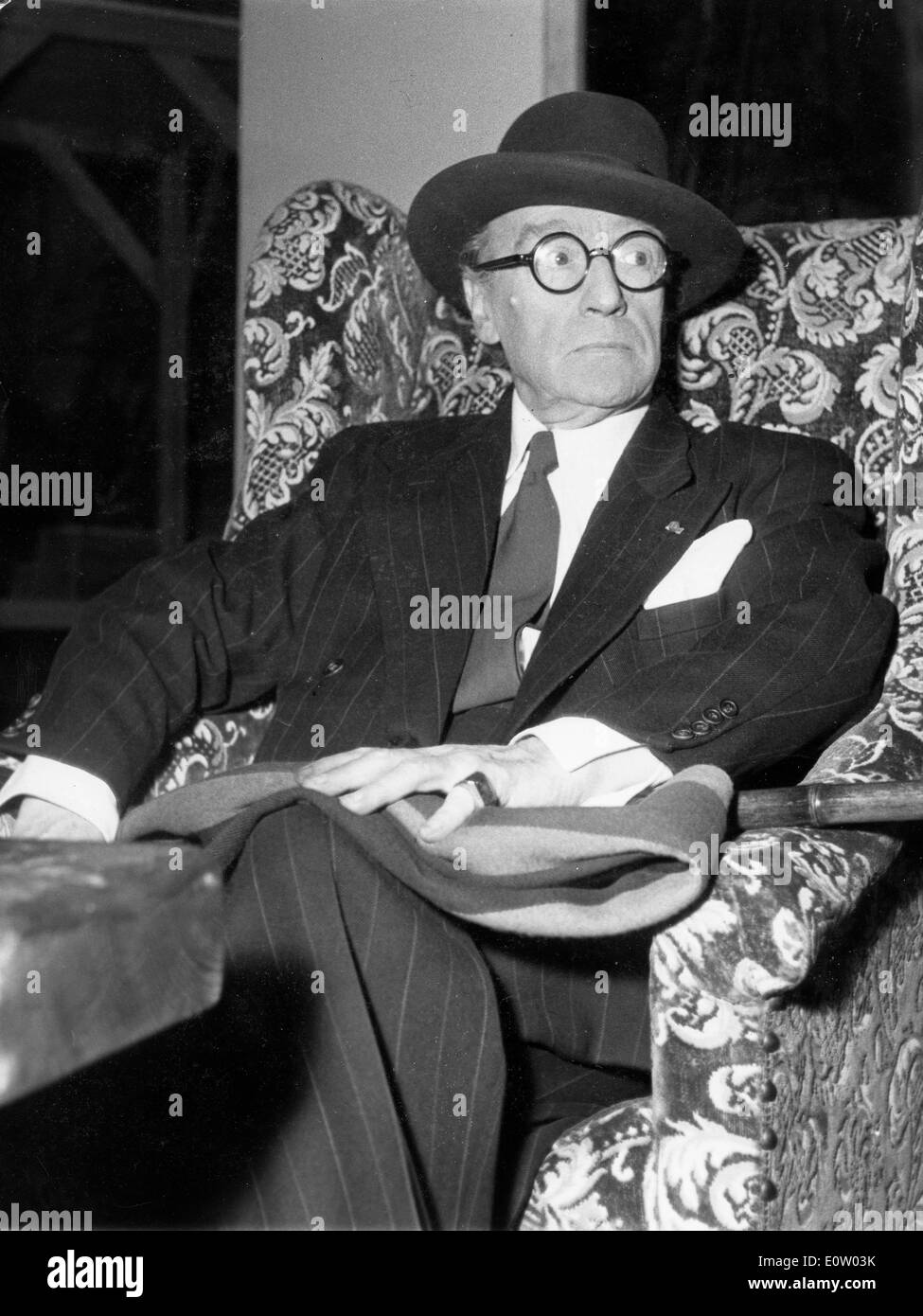 Actor Sacha Guitry relaxes in a chair Stock Photo