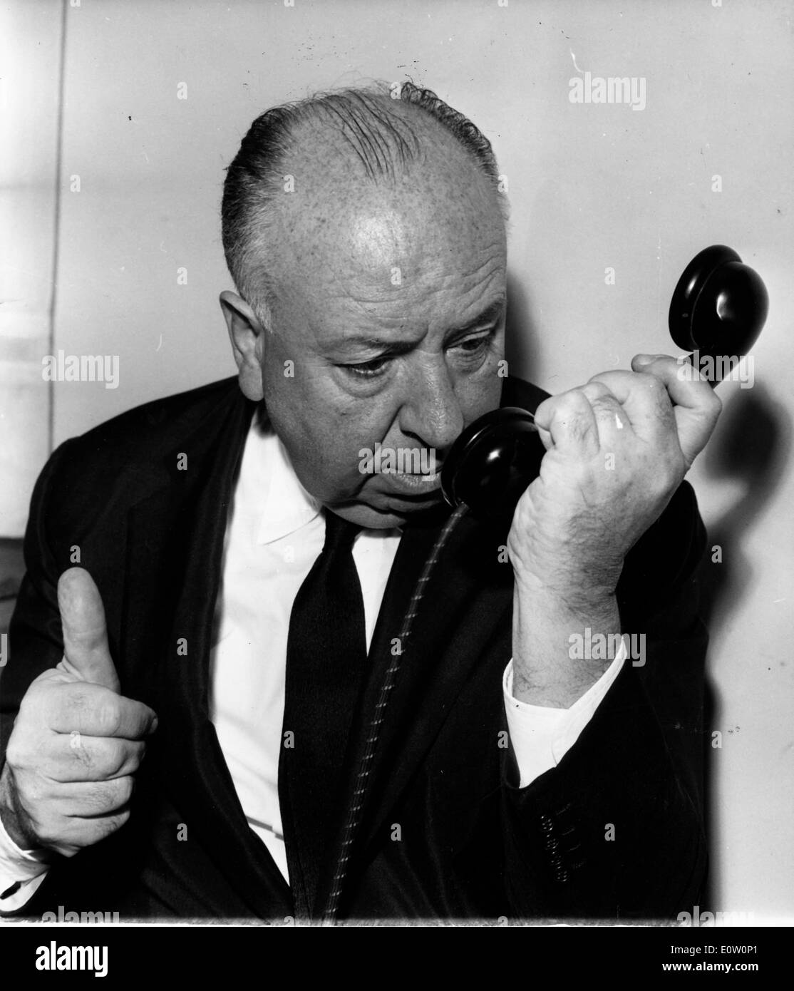 Film director Alfred Hitchcock talking on the telephone Stock Photo