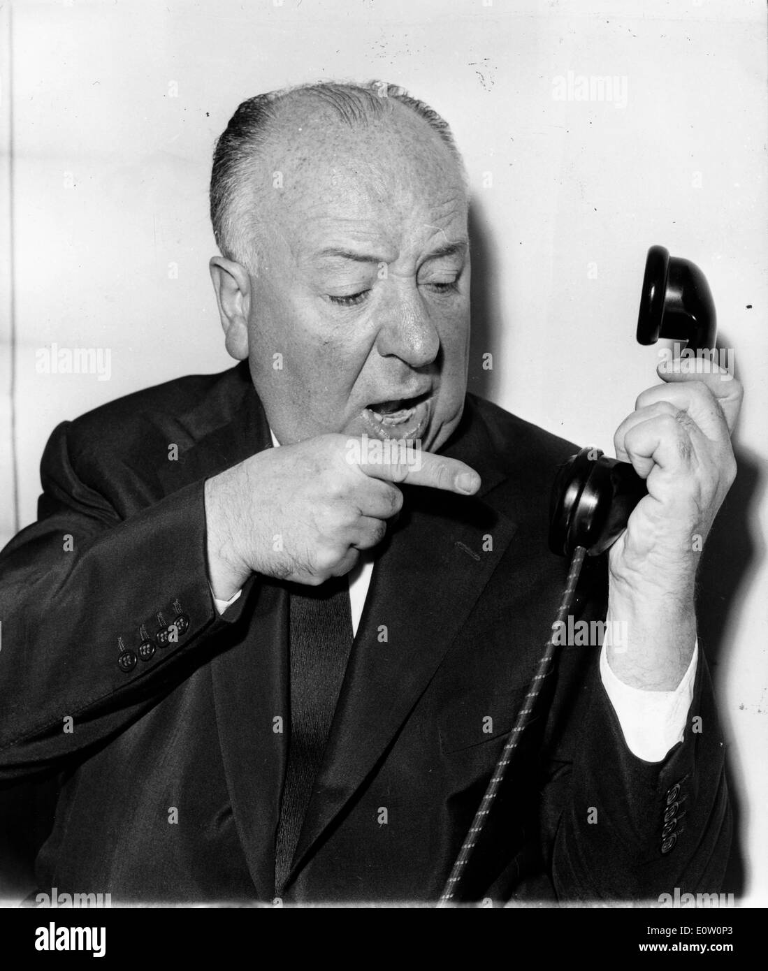 Film director Alfred Hitchcock talking on the telephone Stock Photo