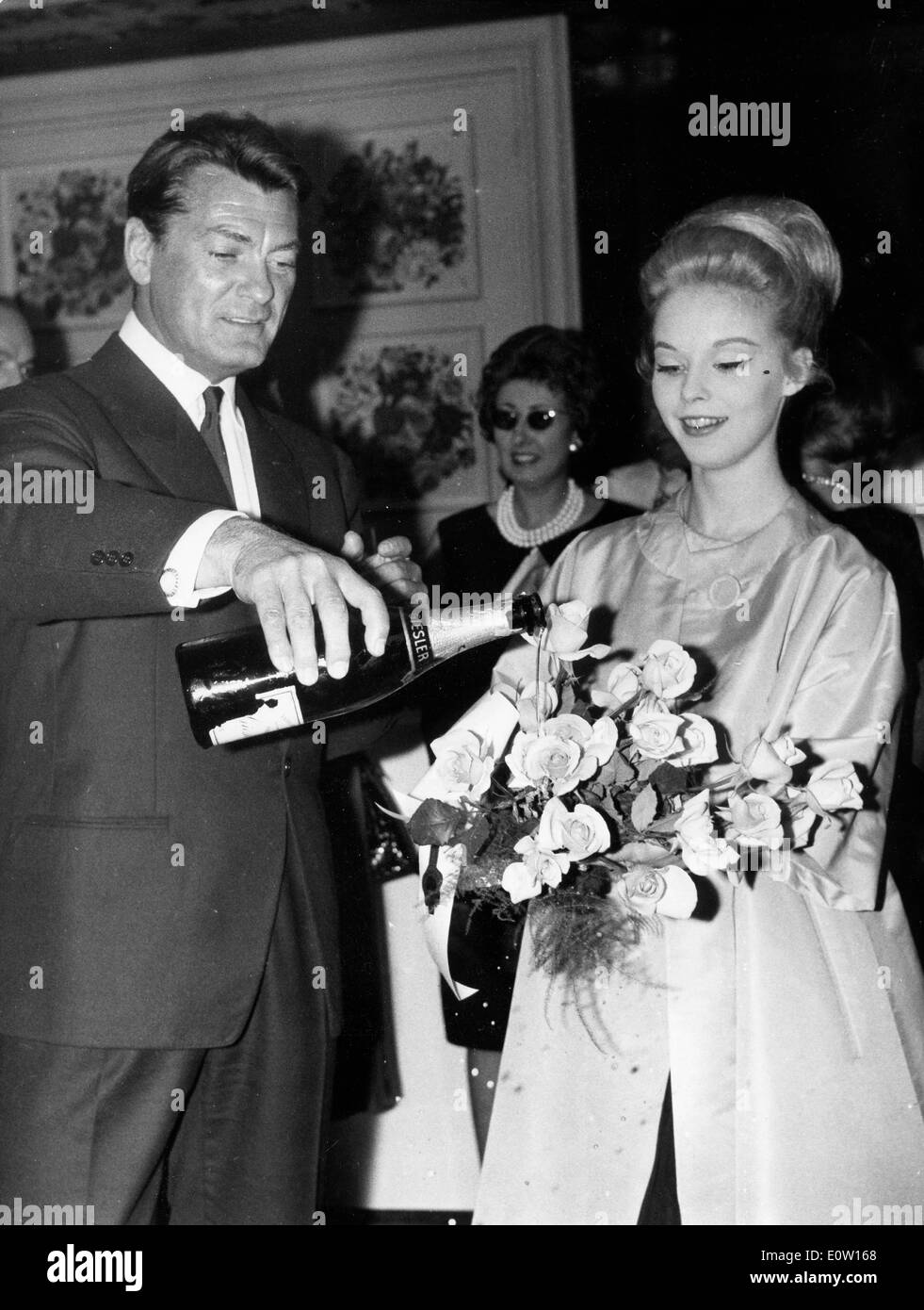 Jean Marais pouring champagne Stock Photo