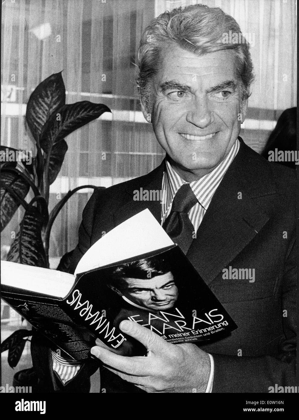 Actor Jean Marais reading his book Stock Photo