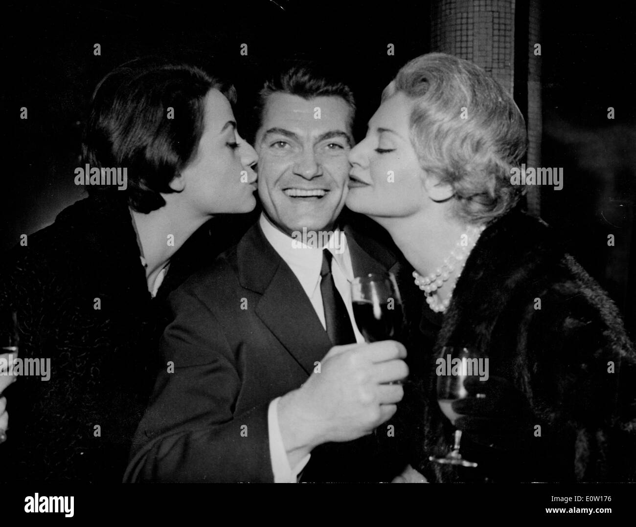 Actor Jean Marais getting kisses from friends Stock Photo