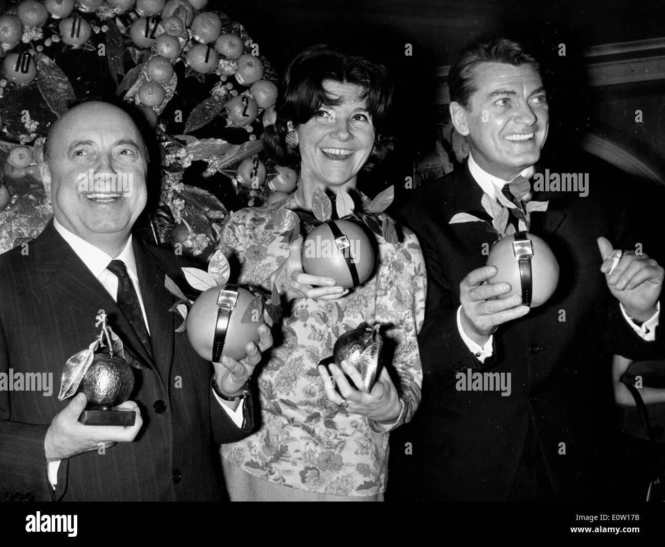 Actor Jean Marais and friends at a party receiving watches Stock Photo