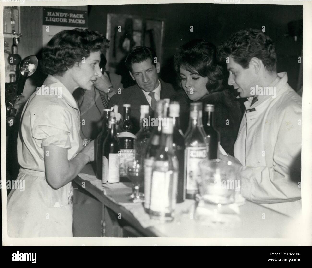 Nov. 11, 1960 - Elizabeth Taylor Leaves for Holiday in the Sun: Elizabeth Taylor whose illness has caused suspension of ''Cleopatra'' filming at Pinewood - left London Airport for Paris - and a holiday in the sun this evening. Picture Shows: Elizabeth Taylor buys a drink for husband Eddie Fisher - at London Airport this Evening. Stock Photo