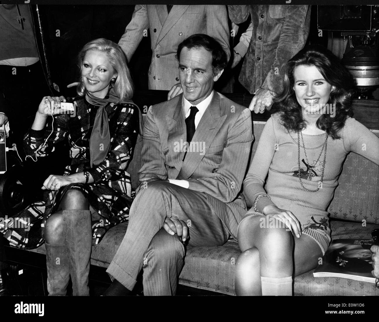 Actress Virna Lisi sitting with friends at a party Stock Photo