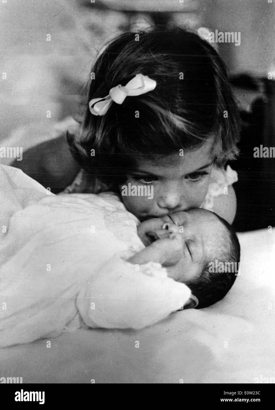 Caroline Kennedy kisses her baby brother John F. Kennedy, Jr. on the head Stock Photo