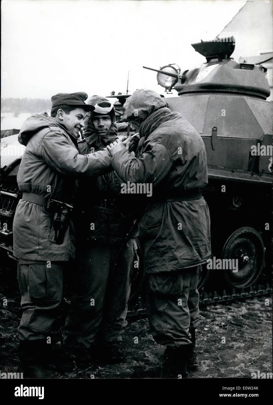 Feb. 02, 1961 - Intermission in the manseuvre: The large NATO manoeuvre ''Wintershield'' began on Feb. 2nd in the district of the training areas Grafenwcher and Hohenfels Southern Germany. In real NATO friendship are smoking (left to right) a German, an American and a French soldier a cigaret. Stock Photo