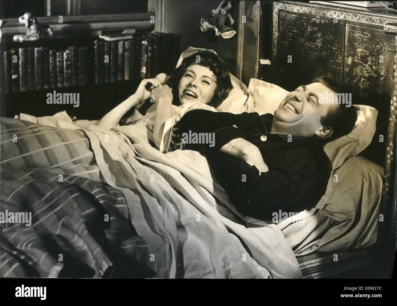 Dec. 12, 1960 - FRANCOIS PERIER COULD NOT STOP LAUGHING FRANgOIS PERISH, THE FAMOUS FRENCH STAGE AND SCREEN COMEDIAN, WHO IS HERE PICTURED IN BED WITH JEAN ShiBLRG NEARLY DROVE MAD FILM DIRECTOR PHILIPPE DE BROCA WHO HAD TO MAKE TEN REPETTITIONS OF THE SHOOTING OF THIS SCENE, A SEQUENCE OF THE FILM ''A LOVER FOR FIVE DAYS'' NOW IN THE MAKING. KNOWN AS A PRACTICAL JOKER AND A GREAT STORY TELLER FRANgOIS PLRUR MUST HAVE THOUGHT OF A GOOD JOKE WHILE FILMING THE SCENE WITH JEAN SLBERG. BOTH ACTORS ROARWWITH LAUGHTER AND THE SCENE HAD TO BE REPEATED TEN TIMES BEFORE THEY QUIETED DOWN. Stock Photo