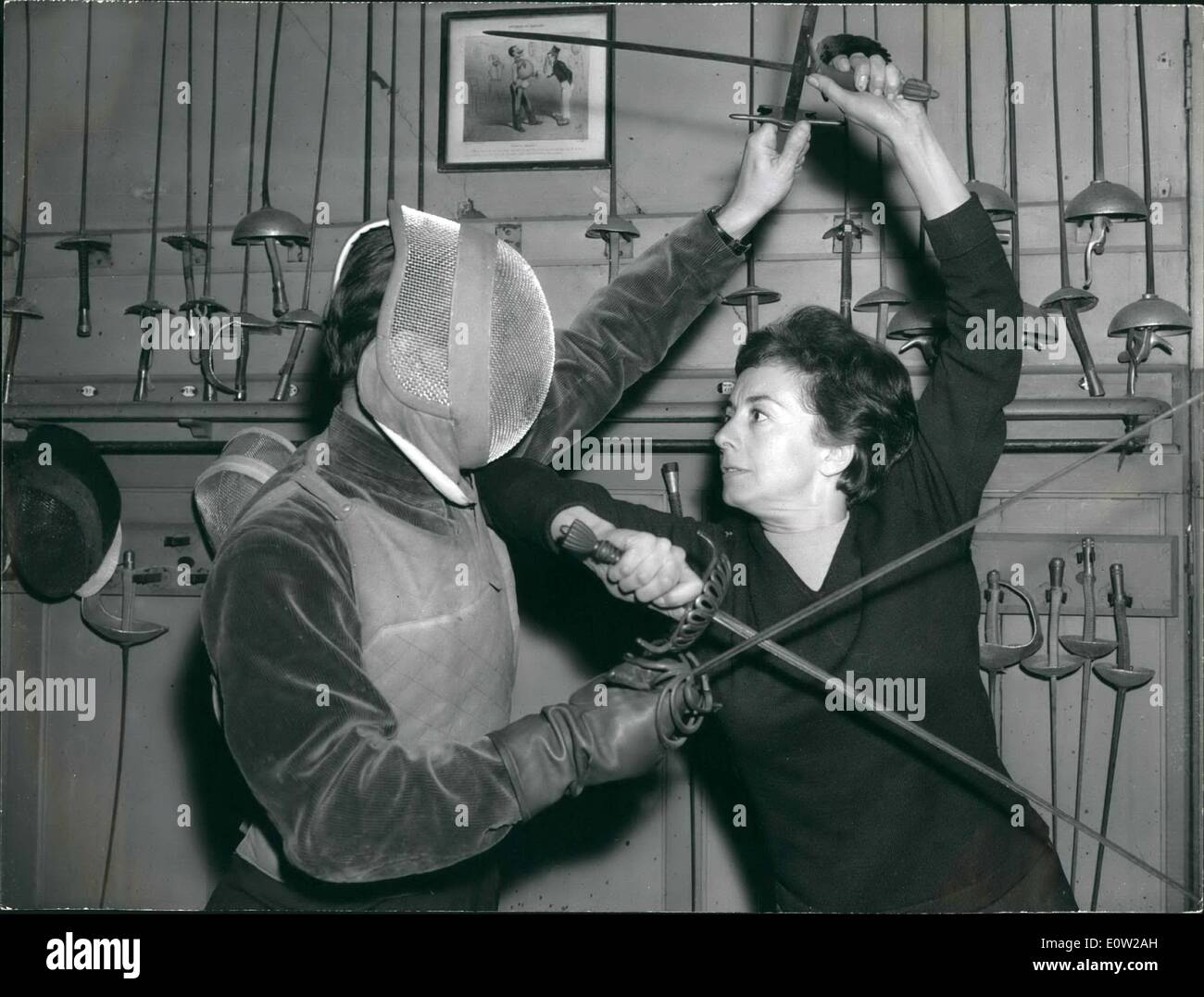 Feb. 02, 1961 - Famous Actress talks up Fencing.: Suzanne Flon, the famous French Actress , has been talking Fencing lessons for her next role in the Kings Night to be staged at Vieux-Colombiers. Photo Shows Suzanne Colombier fencing with her trainer. Stock Photo
