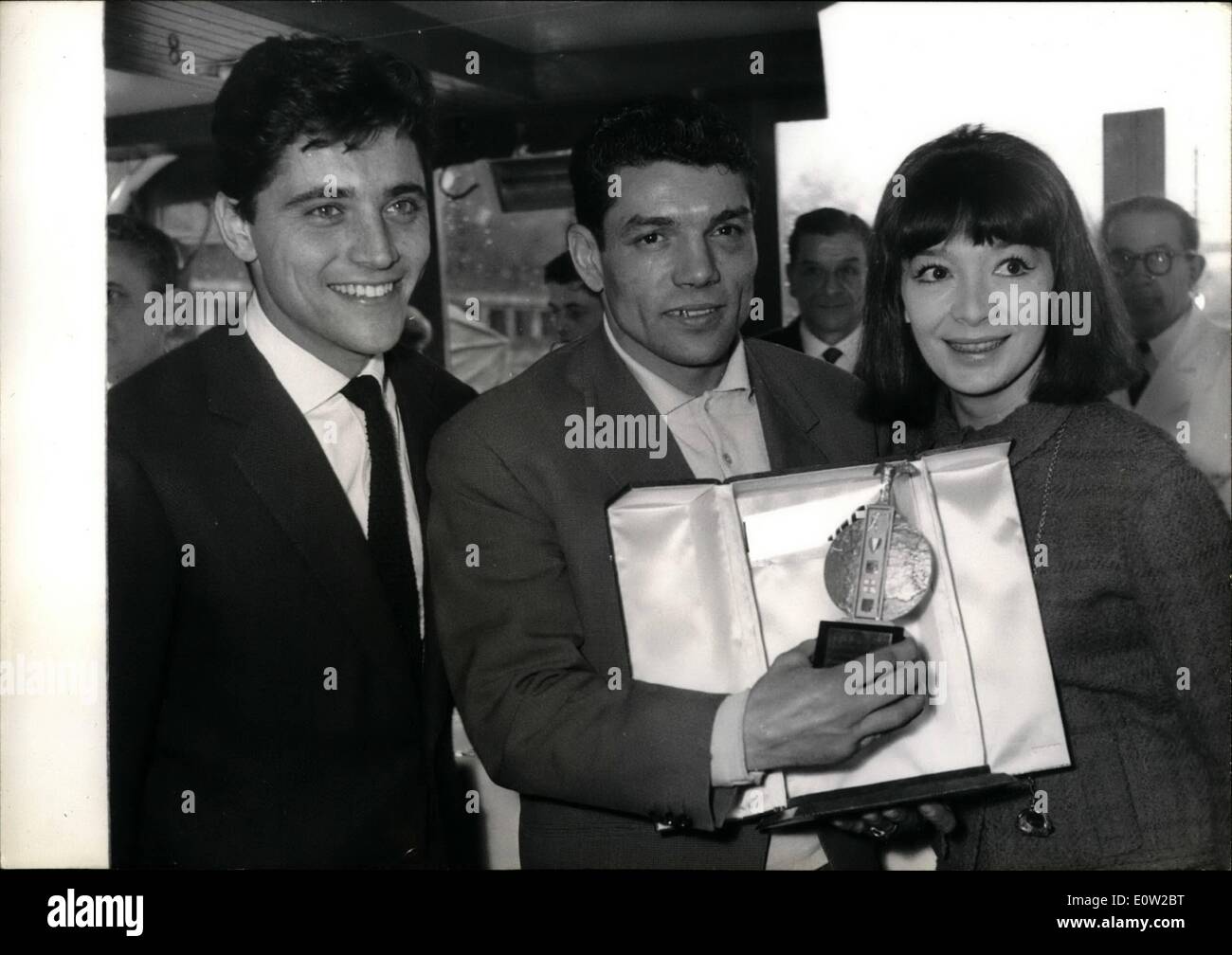 Feb. 02, 1961 - Juliette Greco, Sacha Distel Hand Trophy To Champion Boxer: Isaac Logart and hippolyte Annex who first met at the palais Des sports where they signed their contract the day before yesterday met at a cocktail party hels on board a seine pleasure boat-to-day. the trophy of the best boxer of the year was handed to Hippolyte Annex, French middleweight champion on this occassion. Photo shows. Sacha Distel(left) and Juliette Greco handing the trophy to Hippolyte annex; during the cocktail party to-day. Stock Photo
