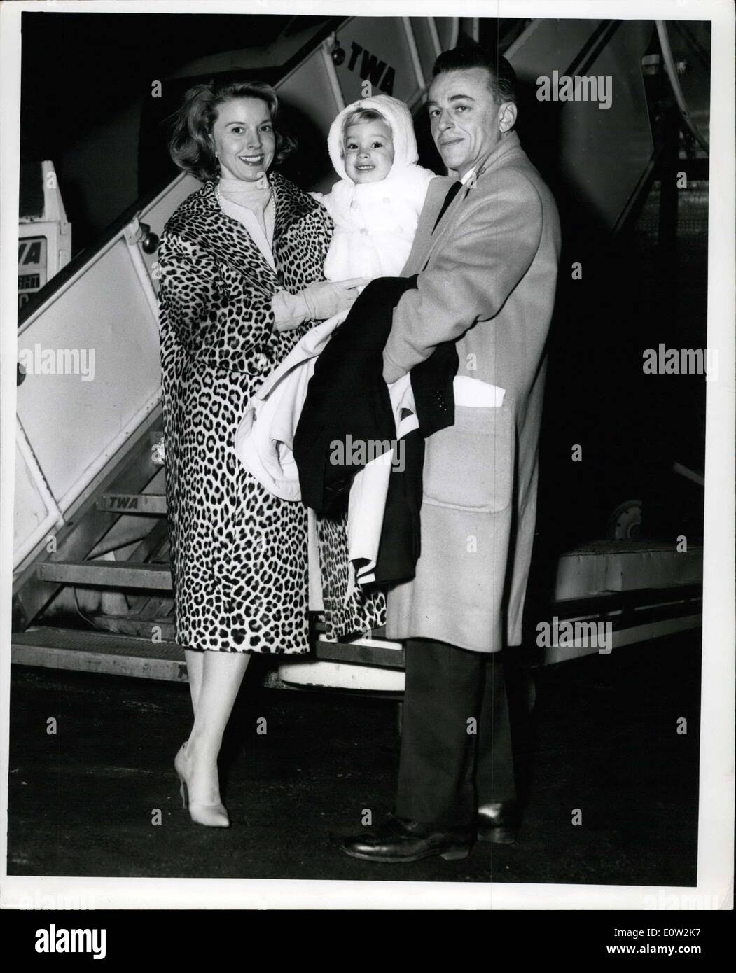Dec. 23, 1960 - For Immediate Release:N.Y. International Airport, December 23, 1960 Alan Jay Lerner, of the famous Lerner &Loewe Musical team, His wife and two year old son Michael Prepare to Board a TWA Super Jet for Paris following his recent opening of the Skash Hit ''Camelot'' on Broad way. The Lerner's will enjoy a winner vacation on the continent for three weeks. Stock Photo