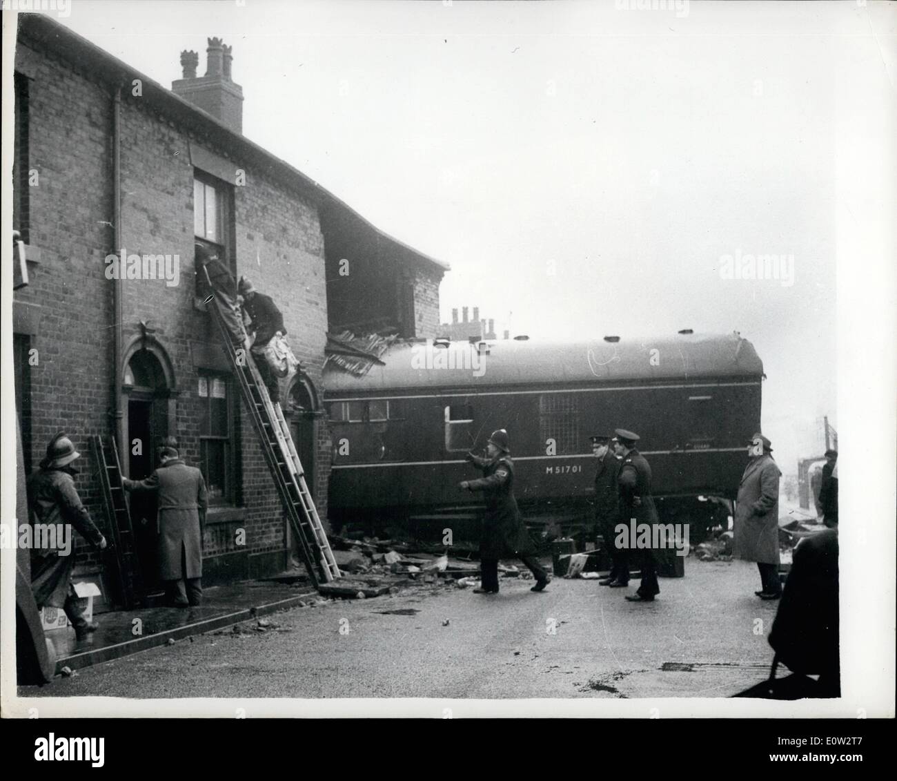 Feb. 09, 1961 - 9-2-61 Runaway train rams houses. Eight people had miraculous escape. Eight people had miraculous escapes from death when a 120-ton diesel train crashed through station buffers and a stone wall to plough across a road and through a row of terraced houses at 35-40 mph. near Oldham, Lancs, yesterday. Driver Harry Pearse sounded his horn for a quarter of a mile as the train hurtled out of control down a gradient into Royton Station. Then, 30 yards from the buffers, the flung himself on to the station platform Stock Photo
