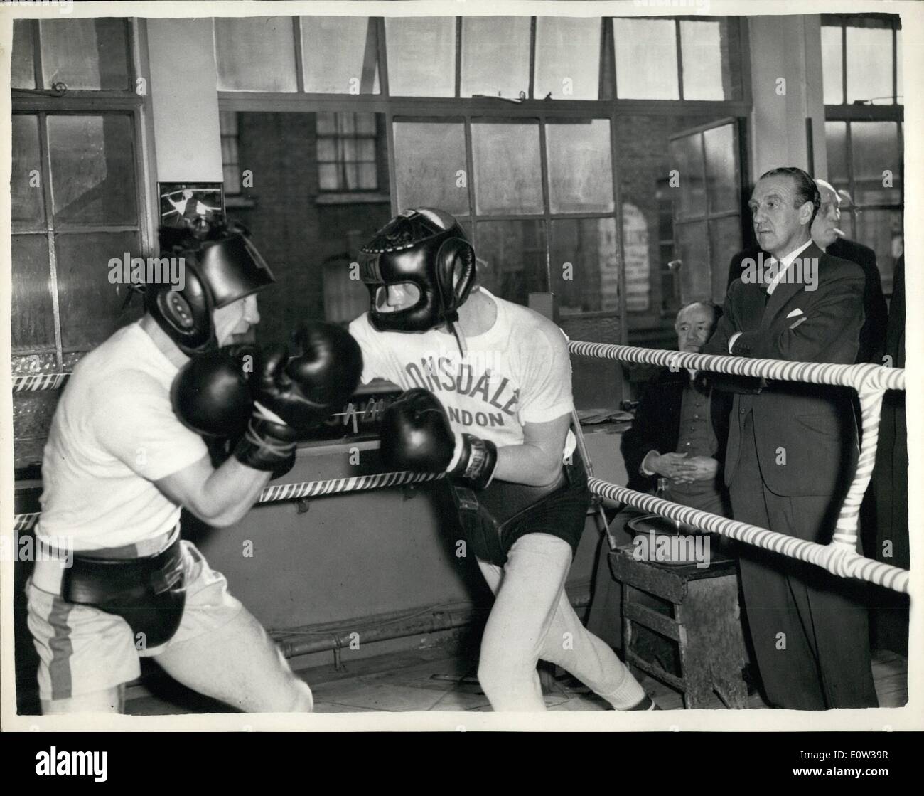 Mar. 03, 1961 - Minister of transport watches Terry Downes in training. Mr. Ernest Marples the minister of transport is a keen follower of boxing - and it was his intention of watching the contests at wembley next Tuesday - which includes the match between Terry Downes middle weight champion - and America's Willie Green - but owing to house of Commons commitments - he will not be able to do so. He went along the bloom's gymnasium - this afternoon to watch Downes in training Stock Photo