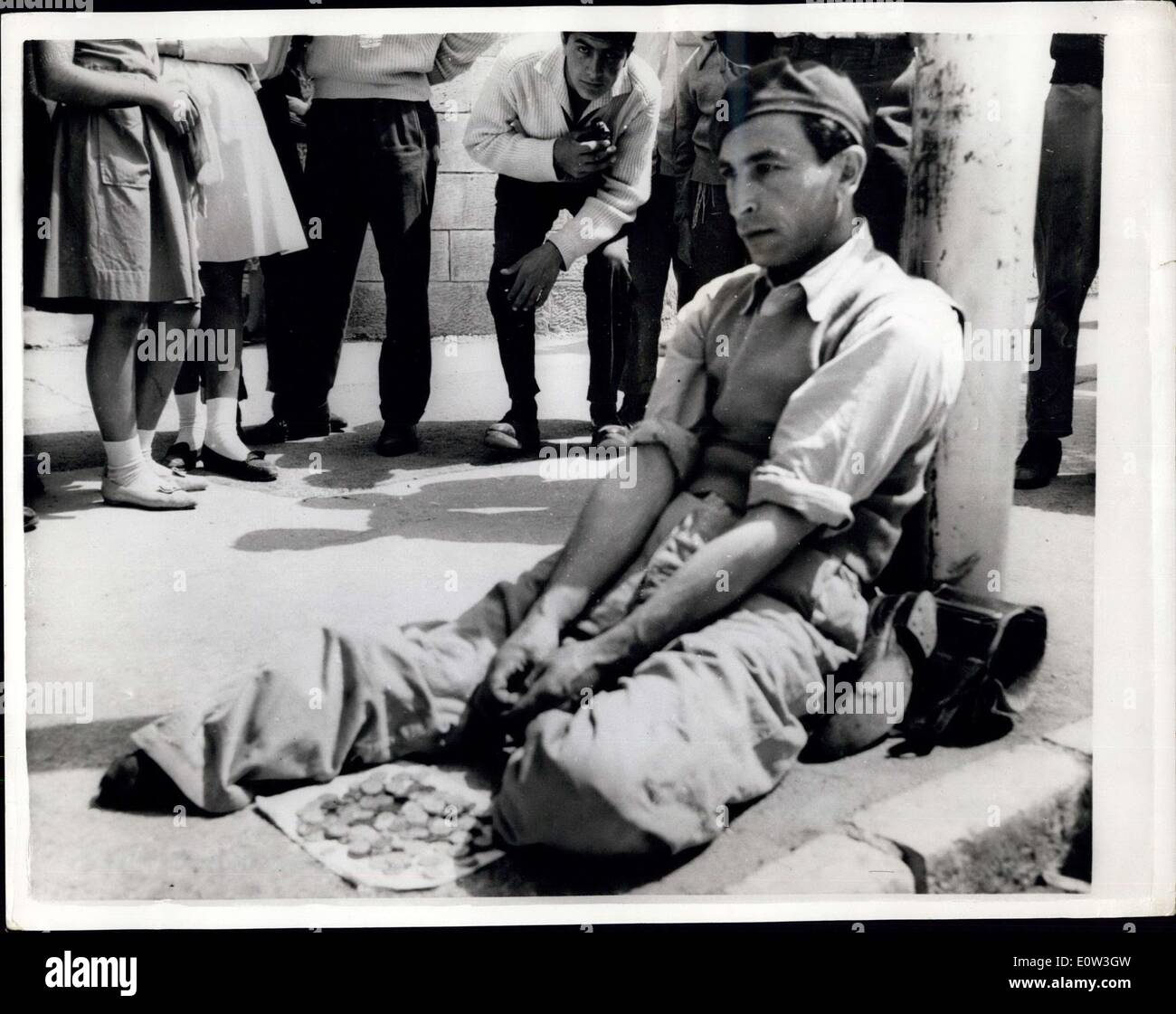 May 31, 1961 - The Eichamann Trial Continues In Jerusalem. Concentration Camp Victim - Outside The Courtroom: The trial of Adolf Eichmann - former Nazi Leader - accused of the mass murder of millions of Jews in wartime concentration camps - continues at Jerusalem. Photo shows A young man in Jerusalem - sits near the Eichamann trial court building - exposing his feet which were crushed in escape from a concentration camp. ''Trying Eichmann wont bring back my broken feet'' says the victim. Stock Photo