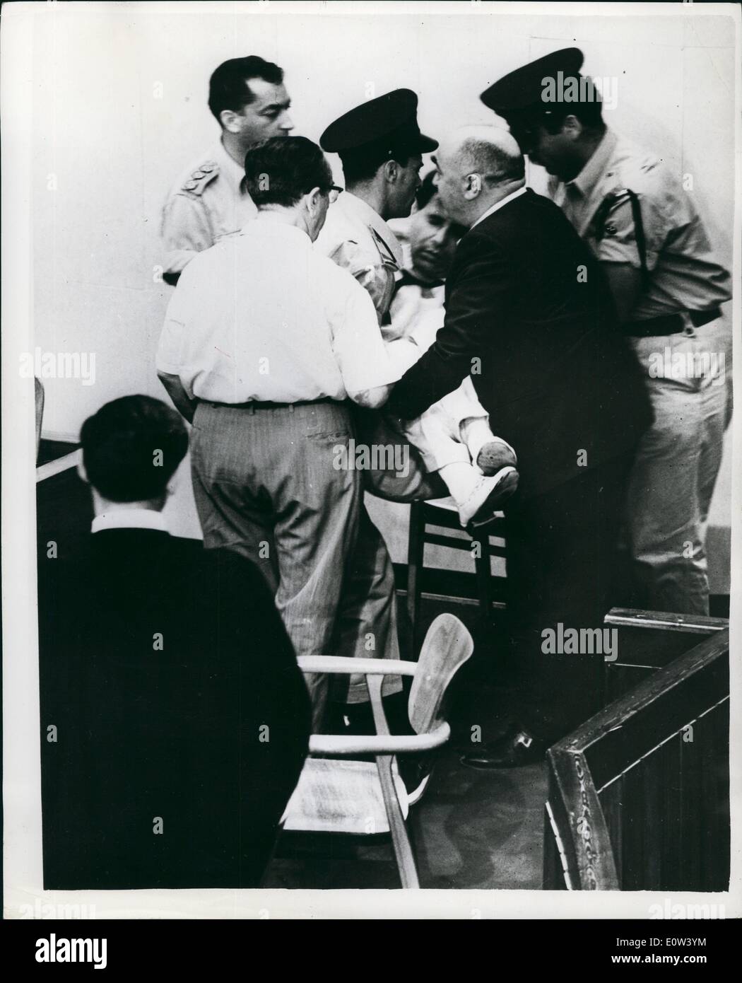 Jun. 06, 1961 - Eichmann trial witness faints: A witness fainted ''as a result of emotional strain'', whilst giving evidence during the Eichmann trial in Jerusalem on Wednesday. He was Israeli author, Yehiel Di-Noor, 72, who wrote ''House of Dolls'' under the pen name of Ka-Tzetnick, which means ''Concentration Camp inmate''. He said he had spent two years at Auschwitz. Photo Shows: The author, Yehiel Di Noor is carried from the court after fainting whilst giving evidence in the Eichmann trial. Stock Photo