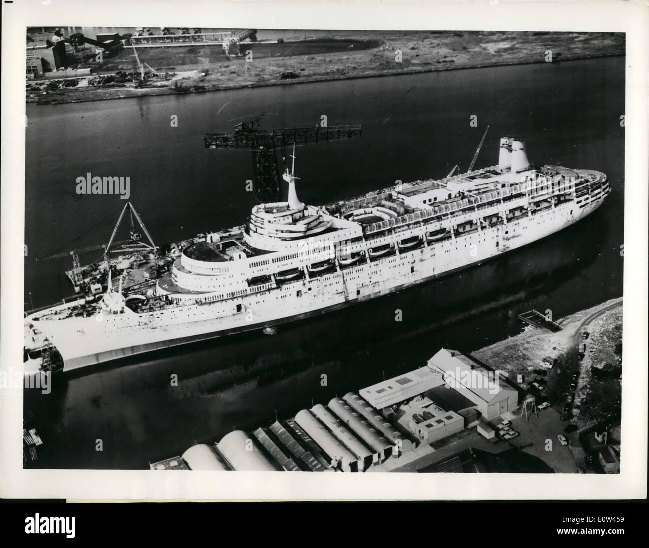 Apr. 04, 1961 - Due In June: In the Belfast, Northern Ireland, shipyard, of Harland and Wolff where 4,000 men are working day and night on her, is the new 45,000-ytons P. and O. liner Canberra, Britain's biggest post war liner for completion on April 29th and to sail on her maiden voyage from Southampton, England, on June 2. The view from above shows some of derivations such as the aluminum bridge and two streamlined stacks,placed aft, instead of normal funnels. Below decks and not shown is an automatic conveyor baggage system Stock Photo