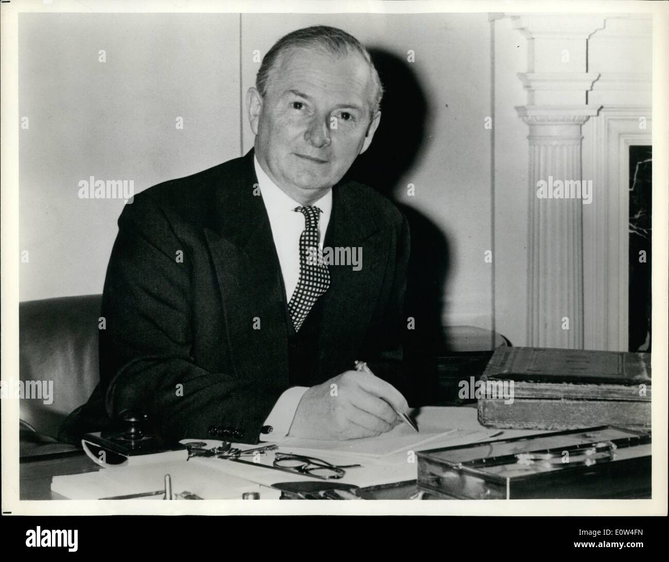 Apr. 04, 1961 - Monday's man in Britain: Mr. Selwyn Lloyd, Britain's Chancellor of the Exchequer, works in his office in the Treasury, London, on the Budget which he will present to the House of Commons and the British people next Monday, April 17. On his desk beside him (right) is the battered red despatch box in which since the 1850's British Chancellors have carried their accounting of the previous year's finances (ending on March 31) and their proposals for the coming year's taxation Stock Photo