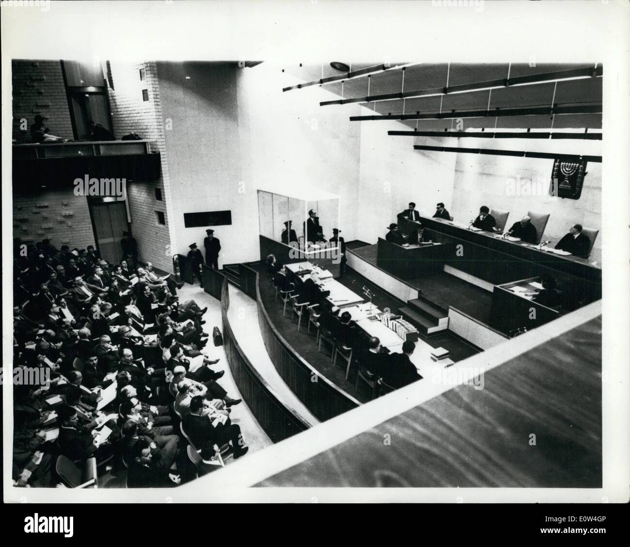 Apr. 04, 1961 - Trial of Adolf Eichmann continues in Jerusalem : The trail continues in Jerusalem of Adolf Eichmann - former Nazi S.s. Colonel - on the charges of mass murder of millions of Jews - in Nazi concentration camps during the war. photo shows General view during the trial showing Eichmann in his bullet - proof dock - Tribunal to the right - and defense and prosecution counsels faction the tribunal. Stock Photo