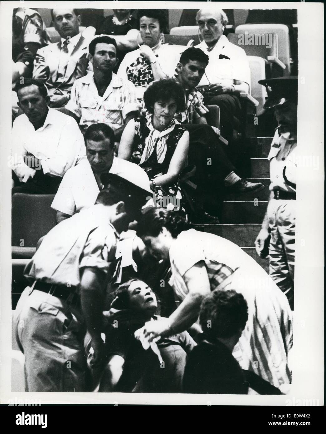 May 05, 1961 - Trial of Adolf Eichmann continues in Jerusalem.: The trial of Adolf Eichmann - former Nazi leader - accused of the murder of millions of Jews in Wartime Concentration Camps - continues in Jerusalem. Photo shows a woman faints at the Eichmann trial - as horrifying documents and read and submitted to the court. The spectators are said to be exceedingly self-controlled - despite the fact that almost every one of them has lost members of their family - in the Concentration camps of Germany and other parts of Europe. Stock Photo