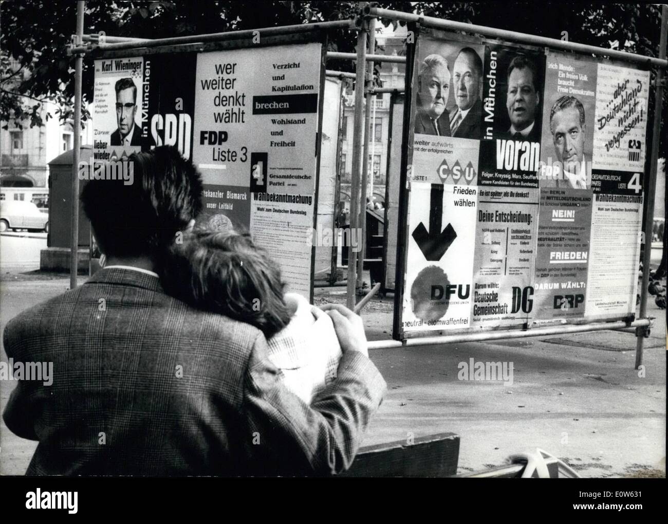 Sep. 09, 1961 - They are talking about love. and dreaming of a happy future - like all the couples in love. Probably they do not look at the election posters opposite to them even if the election is most important for their joint future and for everybody else, too. Stock Photo