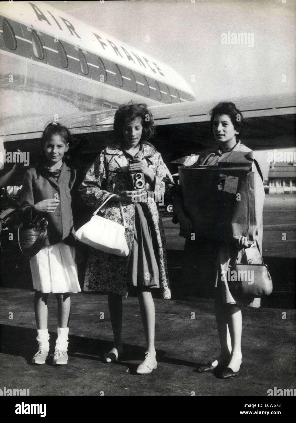 Aug. 04, 1961 - Three little American girl reports on an assignment in Europe.: Three little American girl reporters, Beckie, 13, Debbie, eleven, and Susie, nine, flew back to New York after a tour of the ''Old Continent'' for a leading American women's magazine. Beckie, the photographer, has always her camera handy (''you never know what can happan). Debbie is the designer and Susie, the youngest the writer. Said Susie: ''I was surprised to see that all Frenchmendo not display a moustache and no all of them wear a beret'' Stock Photo