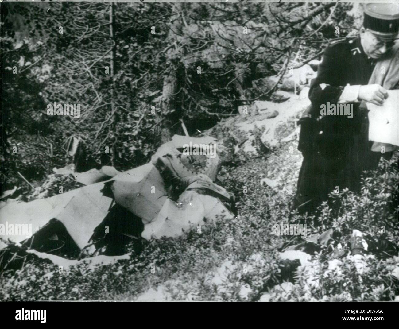 Oct. 10, 1961 - 34 Die as holiday plane hits Pyreness peak: 31 passengers and 3 members of the crew were killed when a Dakota on a charter flight from Gatwick crashed in the Pyrness yesterday. All the passengers were on their way to holidays on the Costa Brava. Photo Shows The wreckage of the plane. In the Foreground a Gerndarme examining different objects found among the wreckage. Stock Photo