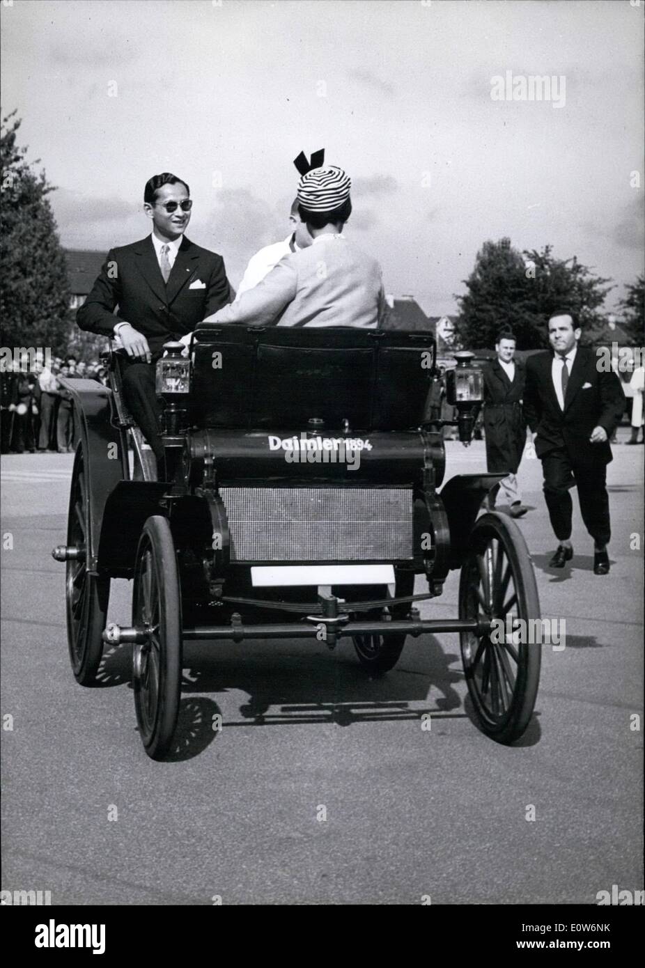 Aug. 08, 1961 - An unexpected speed; developed thee old fashioned Daimler Benz car of 1894 with the king and the queen of Thailand on board. Unexpected for the civil policeman who had the order too an eye on the security of queen Sirikit and king Bhumibol, when they visited the Mercedes-Benz factory museum Stuttgart during their visit in Germany. The policeman had to give ''full speed'' to his feet to fulfill his duty. Stock Photo