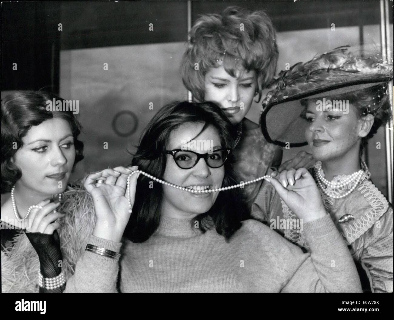 Oct. 10, 1961 - Pearl Necklace for a ''Vocal Pearl'' NANA Mouskourl, The famous Greek singer Known as ''The Pearl of voices'' arrived in Paris today. she is to sing in a Gala performance which will be given at Palais Chaillot in honour of Farah Diba on October is ho will arrive together with the Shah on a state visit next Wednesday. Photo Shows: NANA MOUSKOURI ''Testing'' her Necklace she was Presented with on her arrival at Orly Airport this morning. Stock Photo