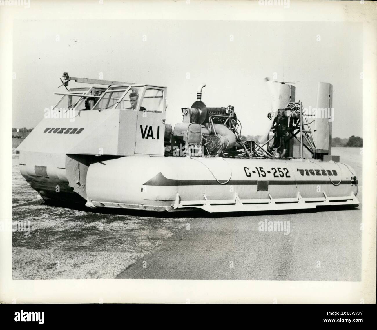 Oct. 10, 1961 - Air ''Wall'' Rider: At South Marston, England, chief test pilot L.R. Colquohoun demonstrates a new British research hovercraft, the Vickers VA-1, claimed by its makers fundamentally different in shape from previous hovercrafts. Capable of remaining stationary, gliding slowly and reaching a speed up to 40 m.p.h., the VA-1 uses an ''air wall'' pumped out under its edges to contain the main, central lifting thrust, thus saving power, increasing the hover-height and reducing spray over water Stock Photo