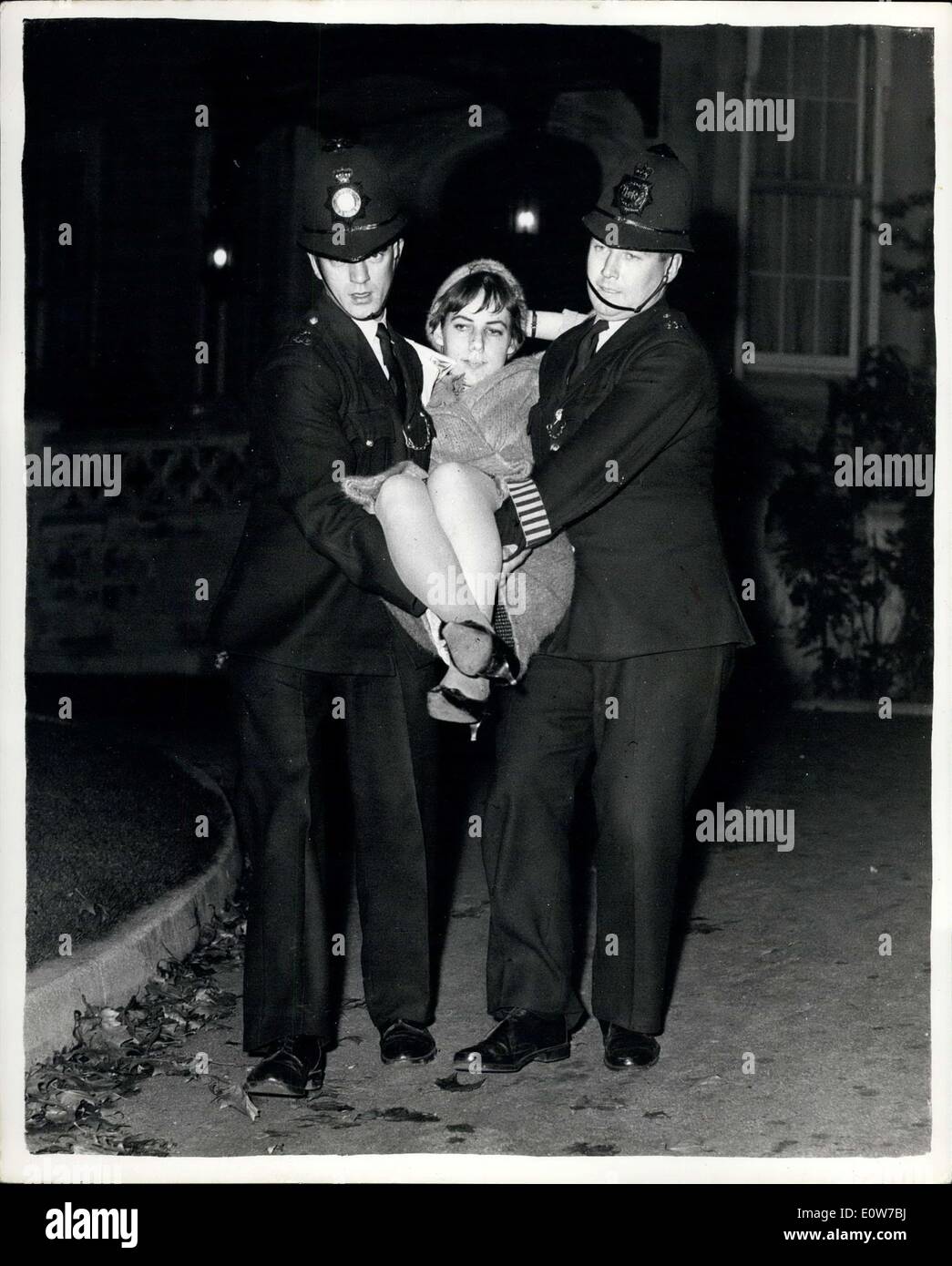 Oct. 18, 1961 - A Squat At The Russian Embassy In London In Protest Against Mr. K. 'S Announcement. Photo shows Two policemen carry 25-year-old Mrs. Anne Davidson out of the Russian Embassy in London early today. She was one of four persons who had settled in there for the night in protest against the Russian plan to explode a monster 50-megaton bomb. All are members of the Committee of 100, the action group of the ban-the-bomb campaign Stock Photo