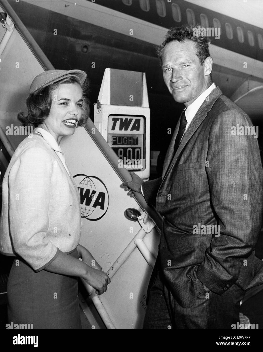 Actor Charlton Heston talking to TWA hostess Nancy Fatenaude as he boards Stock Photo