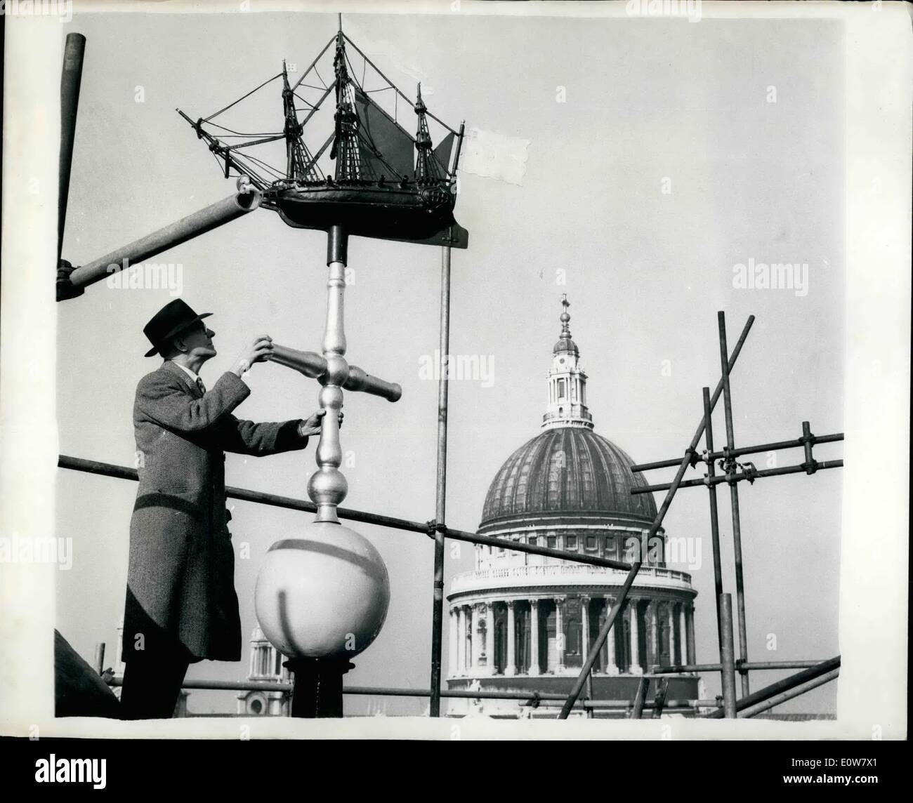 Jan. 01, 1962 - Placing Weather Vane Marks End Of Restoration Of City Church: Placing the ''ship'' weather van in position on the steeple of St. Nicholas Cole Abbay, London, marked one of the final stages of the restoration of the war-damaged church. The weather vane originally stood on St. Queenhithe, built in 1677. photo shows. A workman fitting the weather vane into position on the steeple. St. Paul's can be seen in the background. Stock Photo