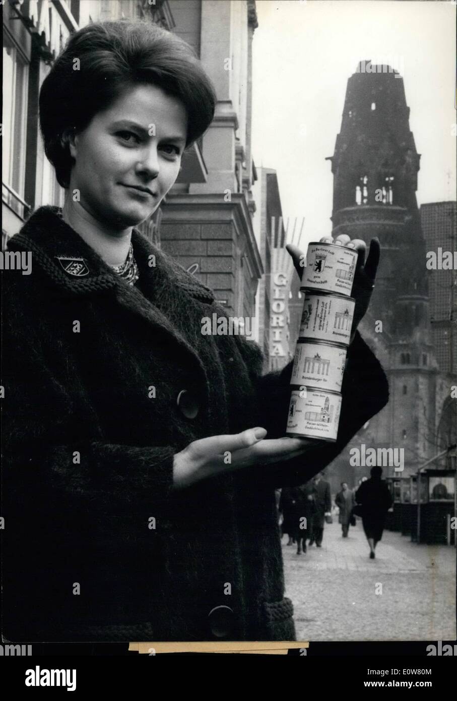 Jan. 01, 1962 - Boxes with ''really Berliner Luft'': are to buy as souvenirs now on Kurfurstendam in West-Berlin. A cunning Berliner has this comical idea and makes his money. Photo shows A young Berlin girl Miss Margaret Kemnitz shows us the boxes with the ''really Berliner Luft'. Background the famous Memorial Church. Stock Photo
