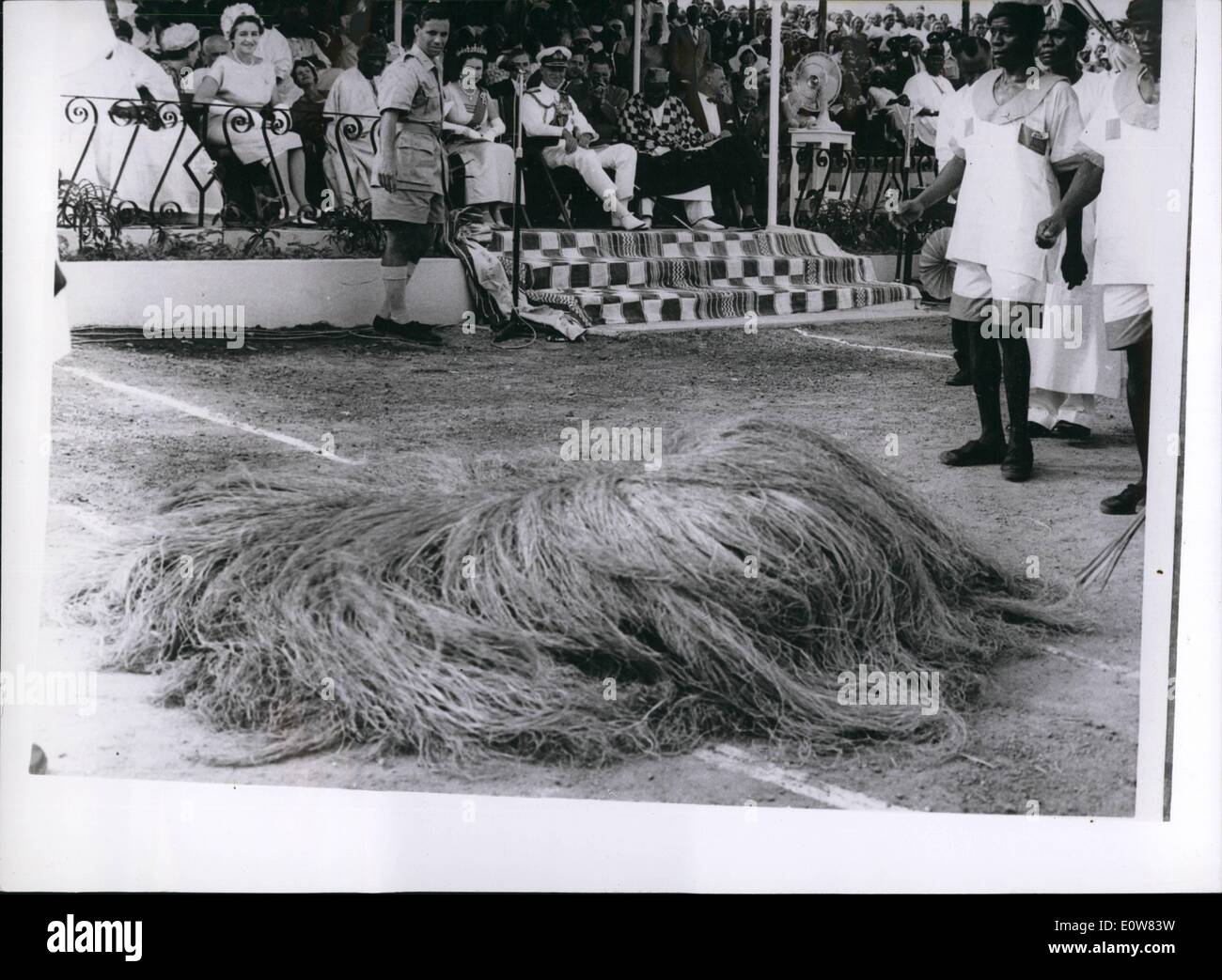 Nov. 11, 1961 - ''Devil Dancers'' Entertain The Queen: The Queen and Prince Philip watched a display of ''devil dancing'' a Durbar at Po on the second day of their tour of the Lone of the interior of Sierra Leona. Photo Shows One of the devil dancers wearing a straw-like costume, ''collapses'' on the ground during the Durbar. Stock Photo