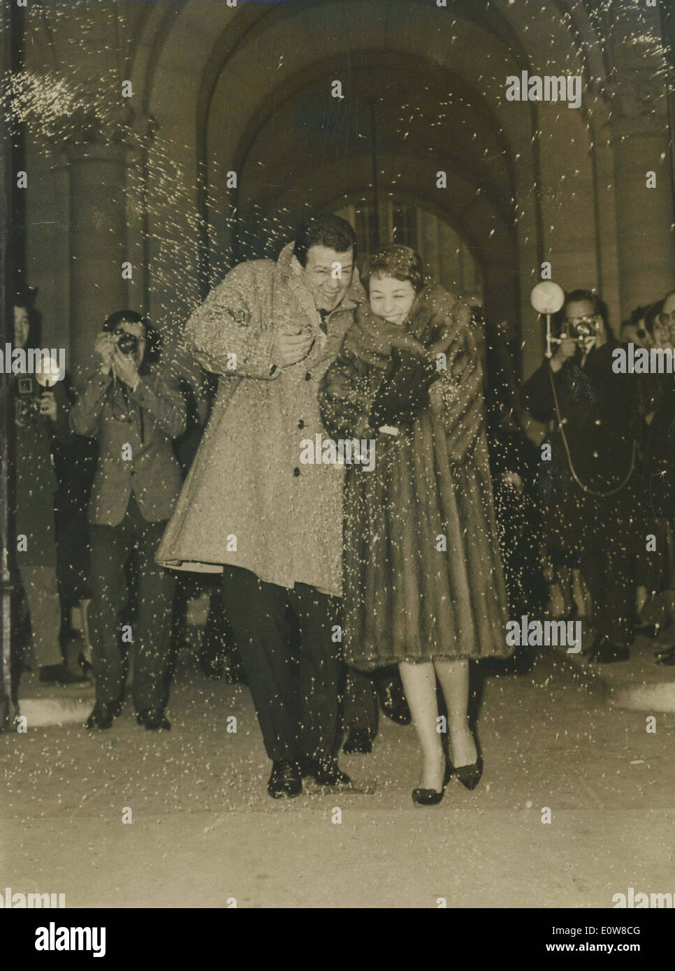 Jan 06, 1962 - Rome, Italy - RENATO SALVATORI and his new bride ANNIE GIRARDOT leave town hall while white rice are thrown in the air. Stock Photo